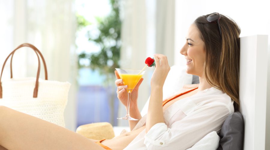Woman enjoying summer vacation in an hotel room